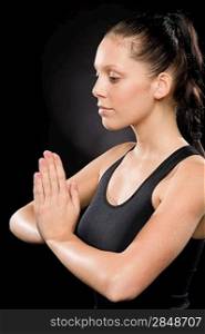 Side view of tranquil woman performing yoga with eyes closed