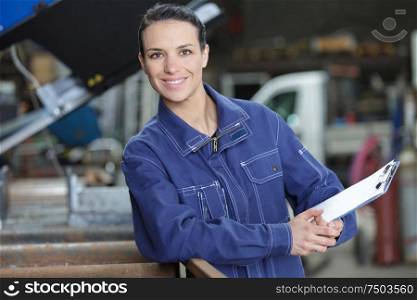 side view of woman holding a clipboard