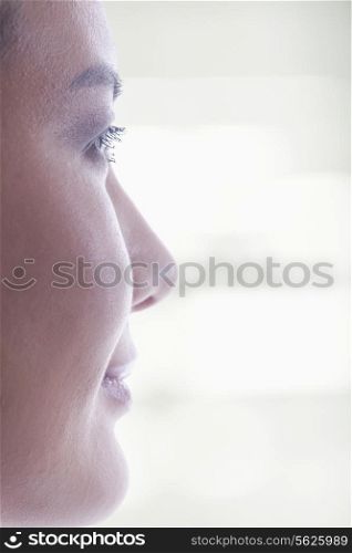 Side view of woman&rsquo;s face on bright background