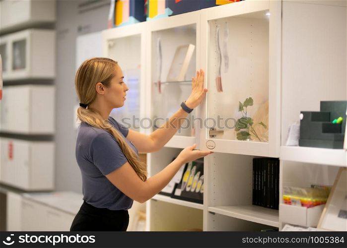 side view of women looking for something on bookshelf
