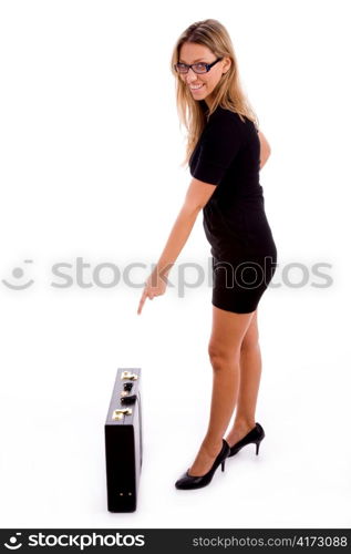 side view of young woman indicating the briefcase on an isolated background