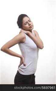 Side view of young woman suffering from backache and shoulder ache isolated over white background