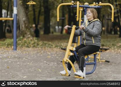 side view older woman working out outdoors with copy space
