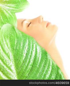 Side view on beautiful woman with closed eyes covered big fresh green leaves with dew drops isolated on white background, enjoying day spa