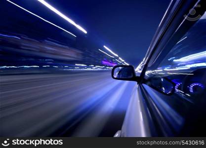 Side view on moving fast car at night