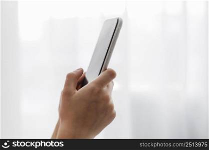 side view person holding mobile phone