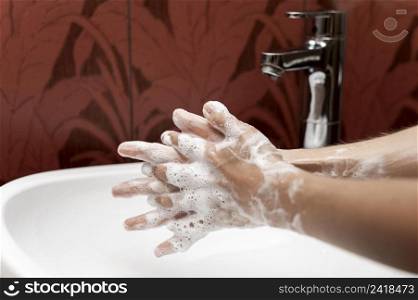 side view person washing hands with solid soap