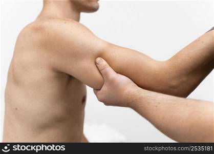 side view physiotherapist massaging man s arm