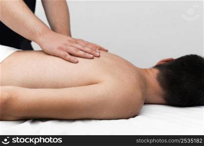 side view physiotherapist massaging man s back