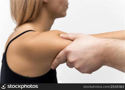 side view physiotherapist massaging woman s arm