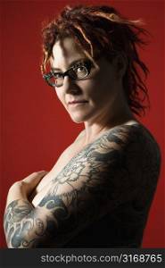 Side view portrait of adult woman with tattoos.