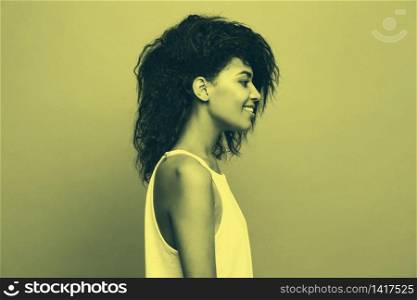 Side view portrait of beautiful attractive African American woman over duotone studio background.. Side view portrait of beautiful attractive African American woman over duotone studio background. Copy Space and duotone.