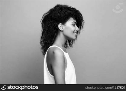 Side view portrait of beautiful attractive African American woman over yellow studio background. Copy Space and duotone. Side view portrait of beautiful attractive African American woman over yellow studio background. Copy Space and duotone.