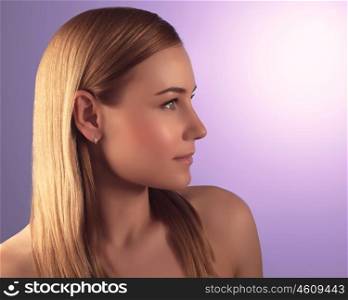 Side view portrait of beautiful woman with natural makeup over purple background, perfect clear skin, beauty treatment concept