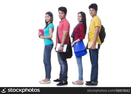 Side view portrait of college students standing in a row over white background