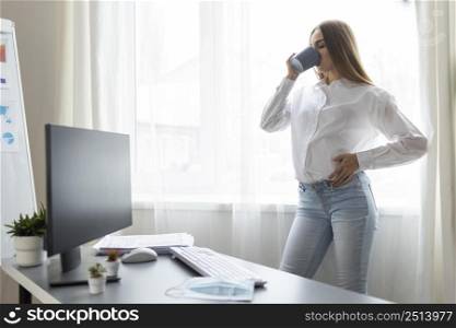 side view pregnant businesswoman having coffee office