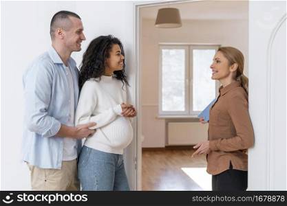 side view realtor inviting couple see new house