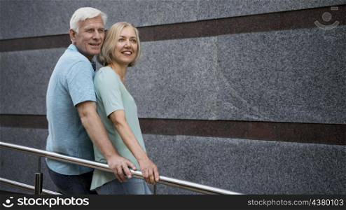 side view senior couple posing together outdoors