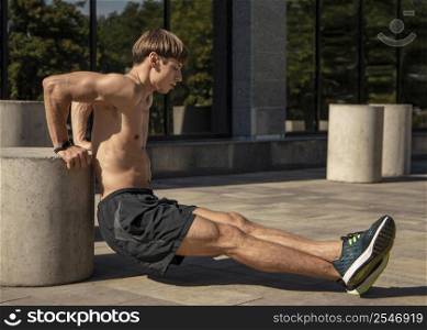 side view shirtless man training outside