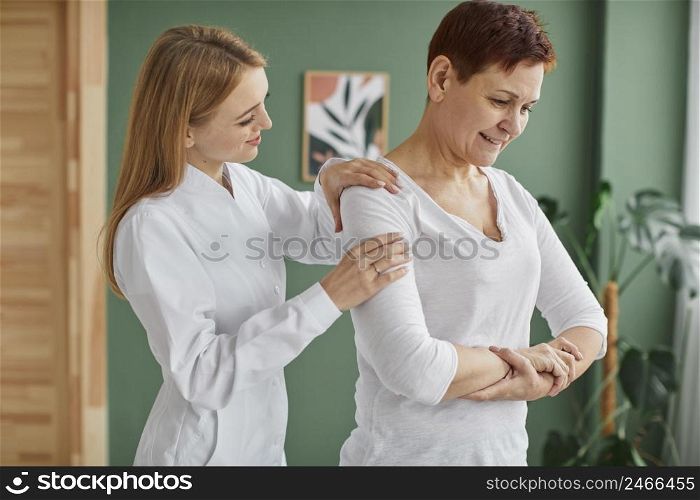 side view smiley elder woman covid recovery doing physical exercises