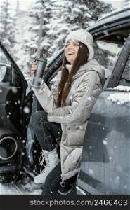 side view smiley woman enjoying snow while road trip