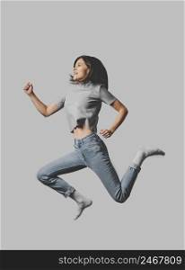 side view smiley woman jumping air
