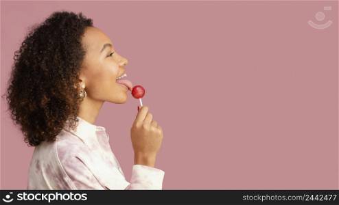 side view smiley woman with lollipop copy space