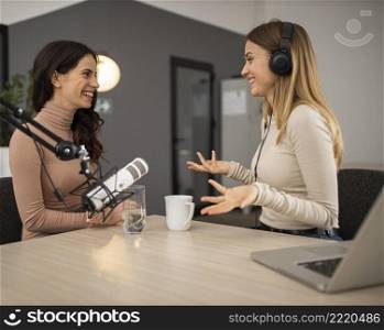 side view smiley women doing radio together