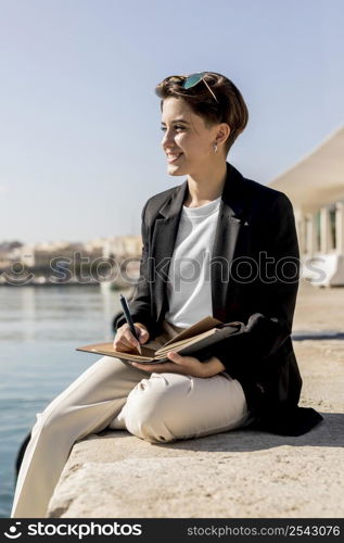 side view stylish woman writing notebook