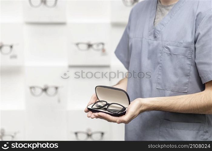 side view view man holding pair glasses case