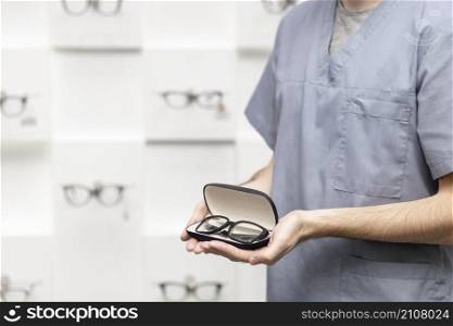 side view view man holding pair glasses case