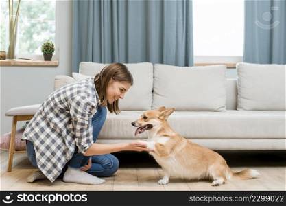 side view woman asking her dog s paw