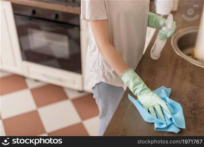 side view woman cleaning kitchen surface. High resolution photo. side view woman cleaning kitchen surface. High quality photo