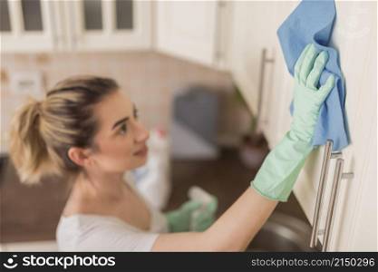 side view woman cleaning surface with cloth kitchen
