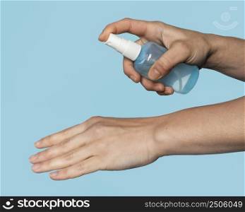 side view woman disinfecting hands
