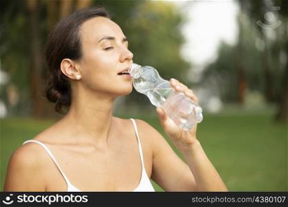 side view woman drinking water