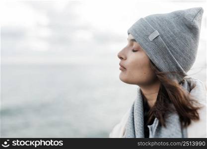 side view woman enjoying ocean breeze with copy space