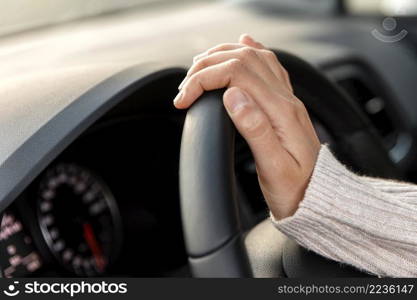 side view woman her car holding steering wheel while driving