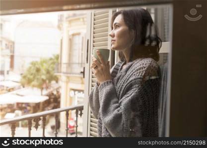 side view woman holding cup coffee