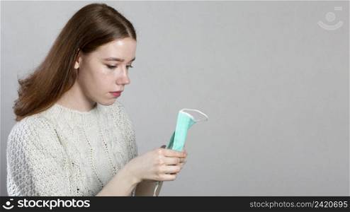 side view woman holding medical mask her hands with copy space