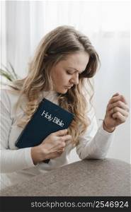 side view woman home holding bible