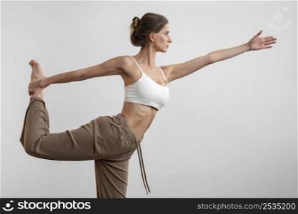 side view woman home practicing yoga