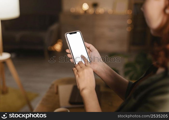 side view woman home using her smartphone