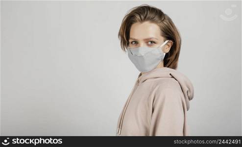 side view woman hoodie with mask