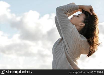side view woman posing against sky with copy space