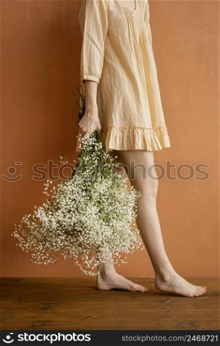 side view woman posing while holding bouquet spring flowers