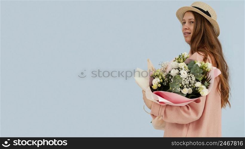 side view woman posing with bouquet spring flowers copy space