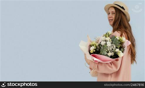side view woman posing with bouquet spring flowers copy space