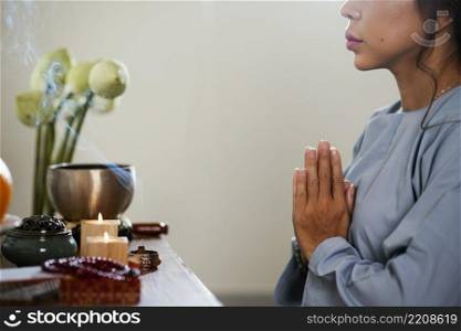side view woman praying front candles