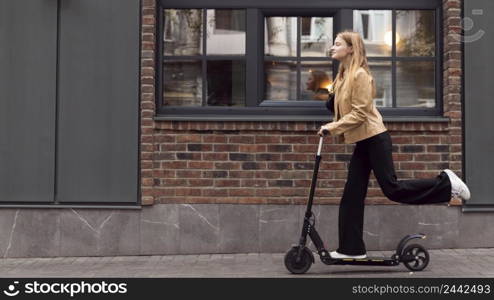 side view woman riding electric scooter outdoors with copy space